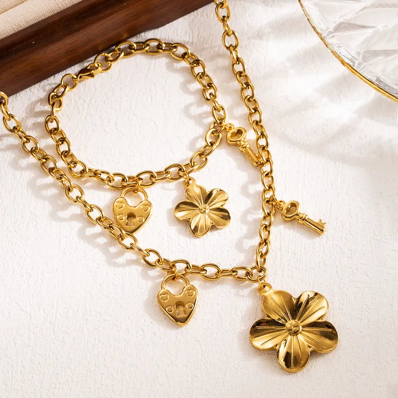 Conjunto flor y llave chapado en oro de 18k